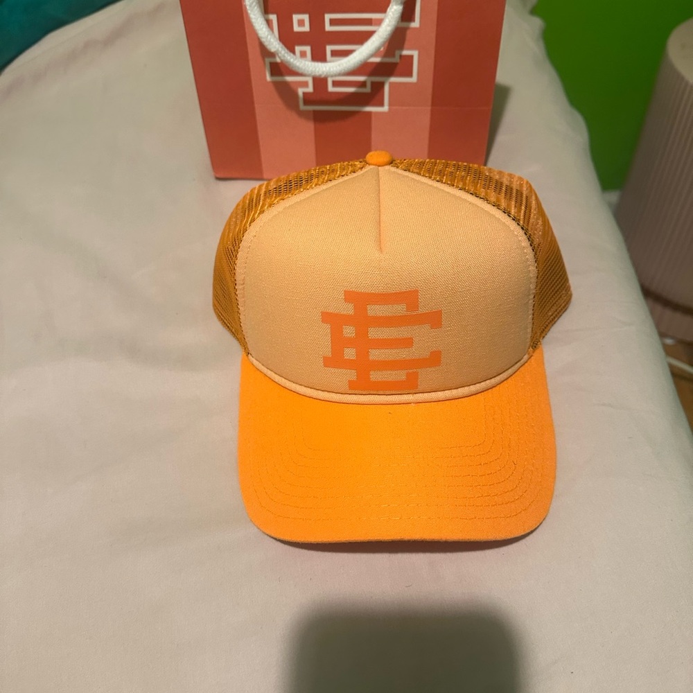 Eric Emanuel Orange Trucker Hat